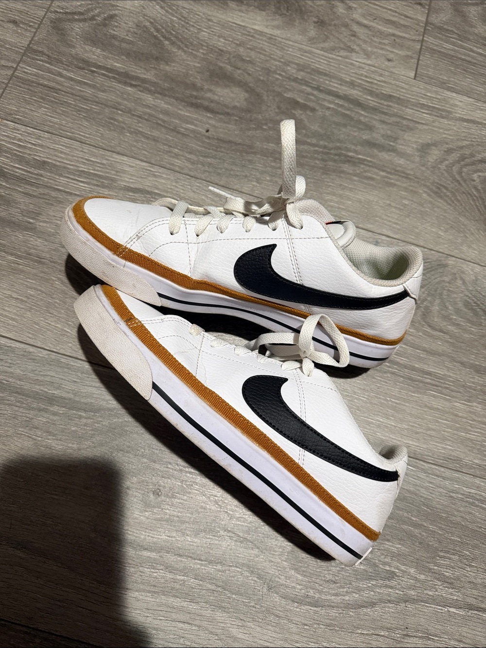 Nike Kids White Sneakers with Black Swoosh and Tan Stripe